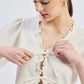 Relaxed Fit Top With Ruffles and Front-Ties in Cream