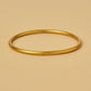 VIRTUOUS CIRCLE GOLD TONE SKINNY BANGLE